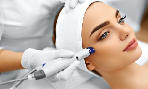 Face Skin Care. Close-up Of Woman Getting Facial Hydro Microdermabrasion Peeling Treatment At Cosmetic Beauty Spa Clinic. Hydro Vacuum Cleaner. Exfoliation, Rejuvenation And Hydratation. Cosmetology.